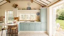 The beamed ceiling and patio doors add charm to this lovely kitchen.