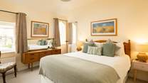 Another bright and airy bedroom with king-size double bed and more original windows.