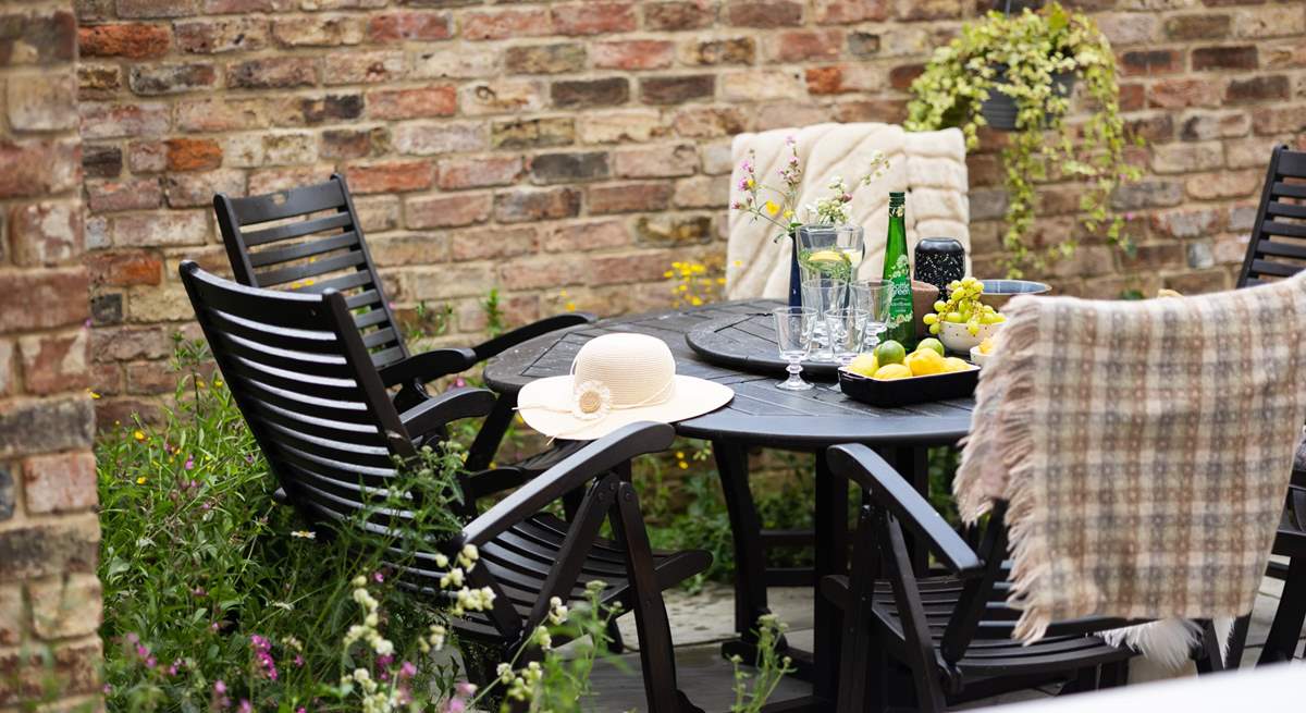 Pretty wildflower borders surround the courtyard garden.