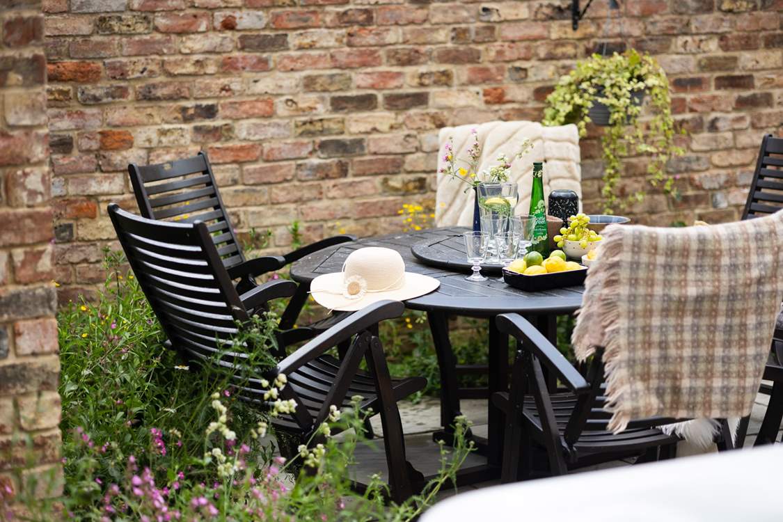 Pretty wildflower borders surround the courtyard garden.