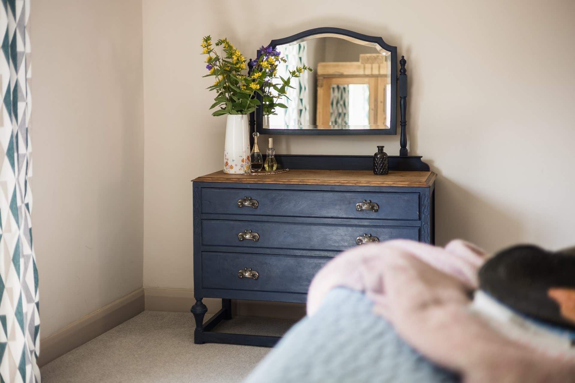 Vintage furniture makes a stylish statement in the bedroom.