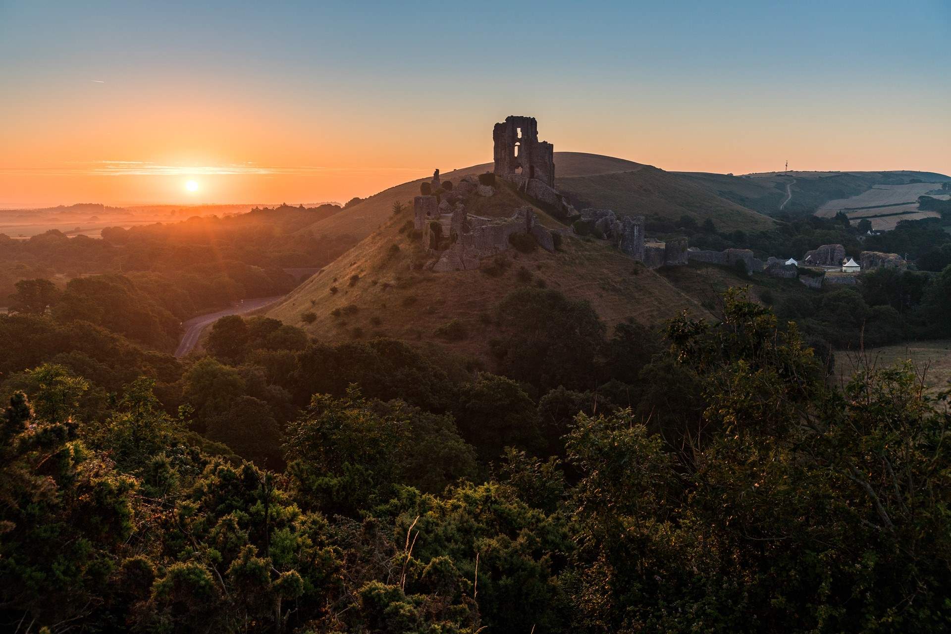 Head further east in the county to the Purbecks and watch the sun set over Corfe Castle.
