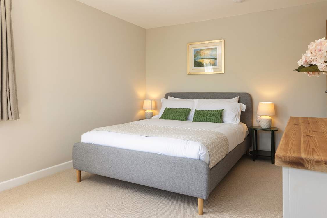 Calming tones ensure total relaxation in bedroom 1...