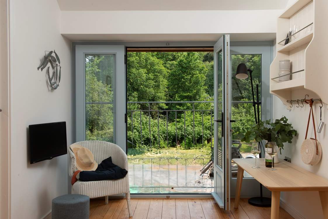 Open up the large door and let the fresh air in. You are moments from the sea.