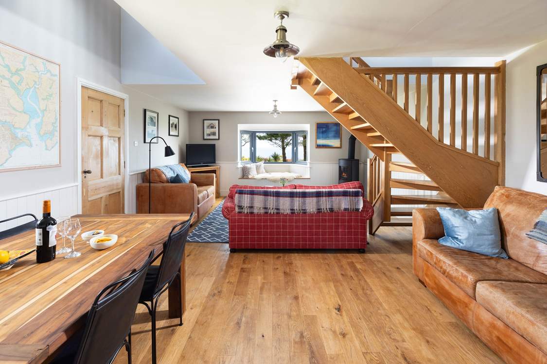 The open plan sitting/dining-room has plenty of seating allowing you to enjoy the view out the window.