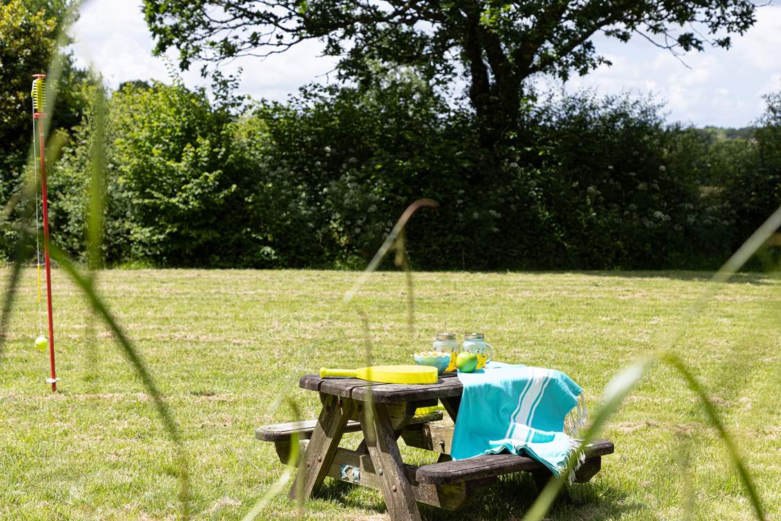 Your little people can enjoy their own picnic table after a game of swing ball.