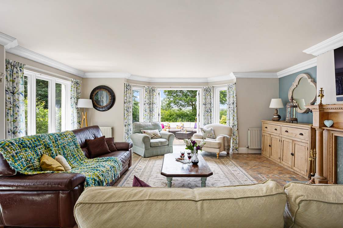 The sitting-room floods with light and opens up to the gloriously large garden and entertainment terrace.