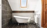 The bedroom comes complete with a delightful en suite bathroom featuring an elegant roll-top bath. - Thumbnail Image