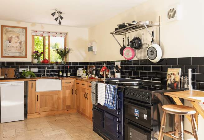 A monochrome marvel - this fully equipped kitchen has both a lovely feature Aga and a conventional oven.