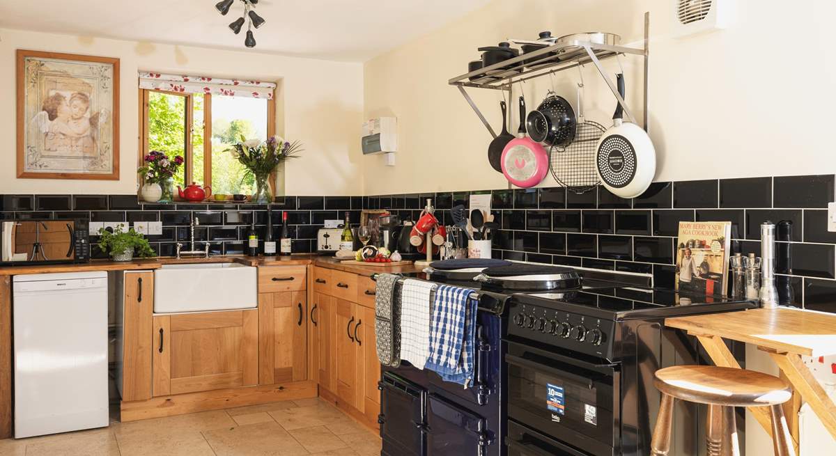 A monochrome marvel - this fully equipped kitchen has both a lovely feature Aga and a conventional oven.