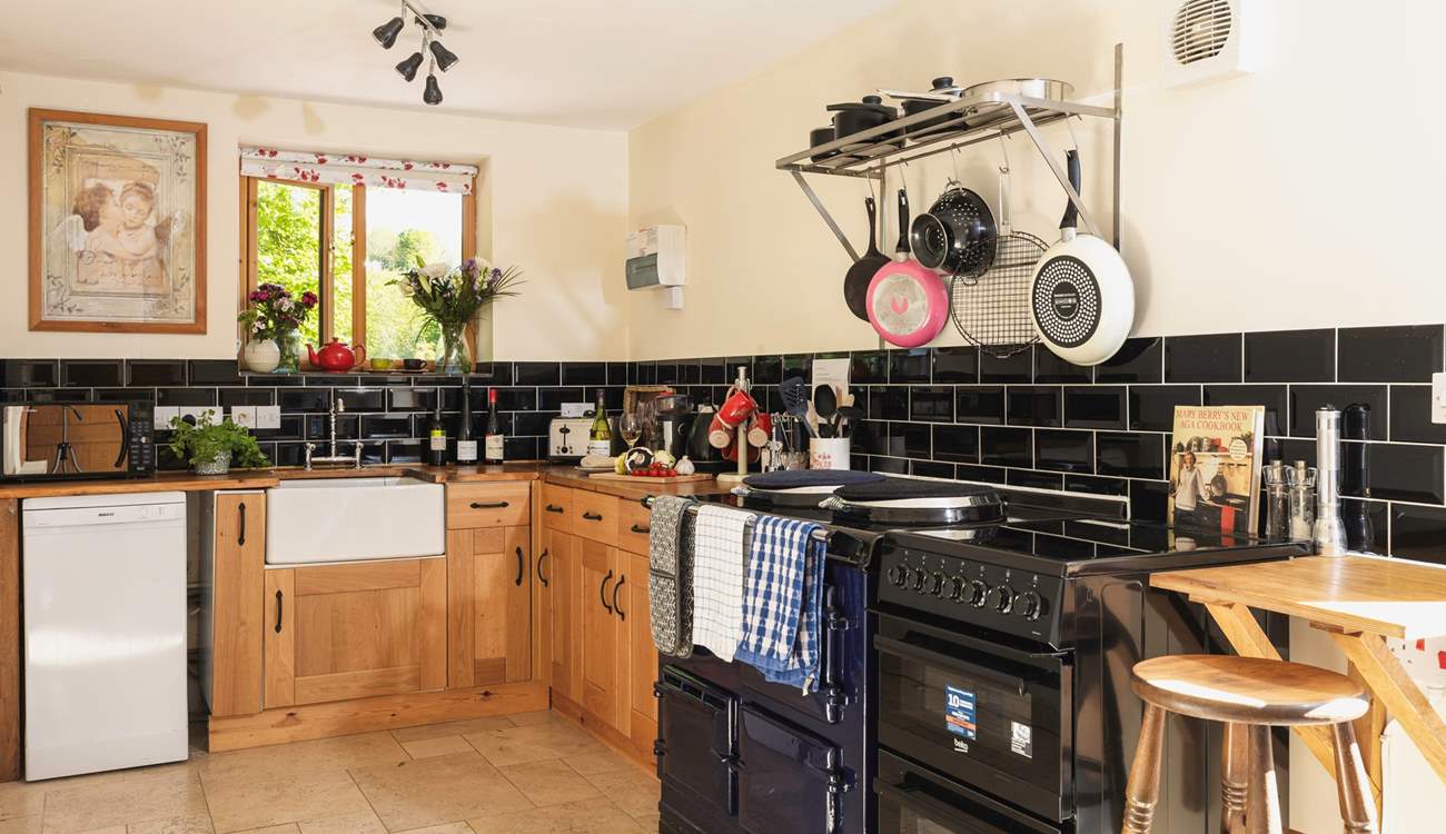 A monochrome marvel - this fully equipped kitchen has both a lovely feature Aga and a conventional oven.