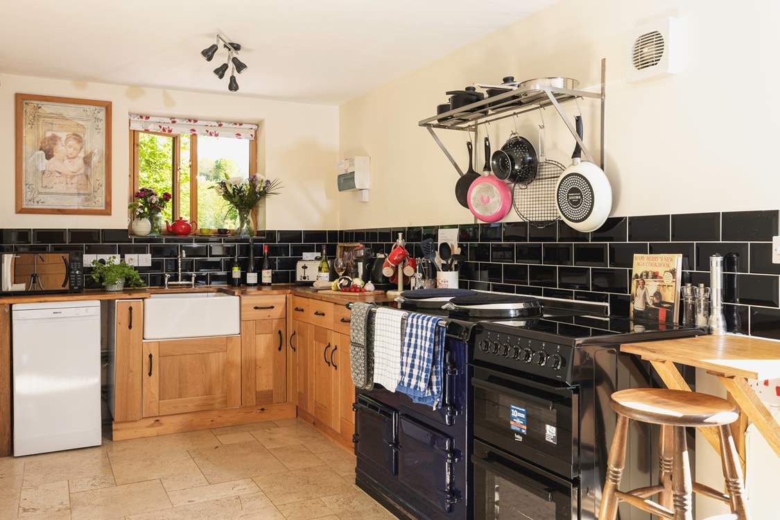 A monochrome marvel - this fully equipped kitchen has both a lovely feature Aga and a conventional oven.