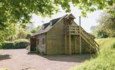 The upstairs bedroom is accessible via an outdoor staircase. - Thumbnail Image