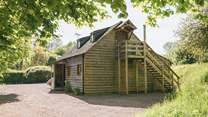 The upstairs bedroom is accessible via an outdoor staircase.