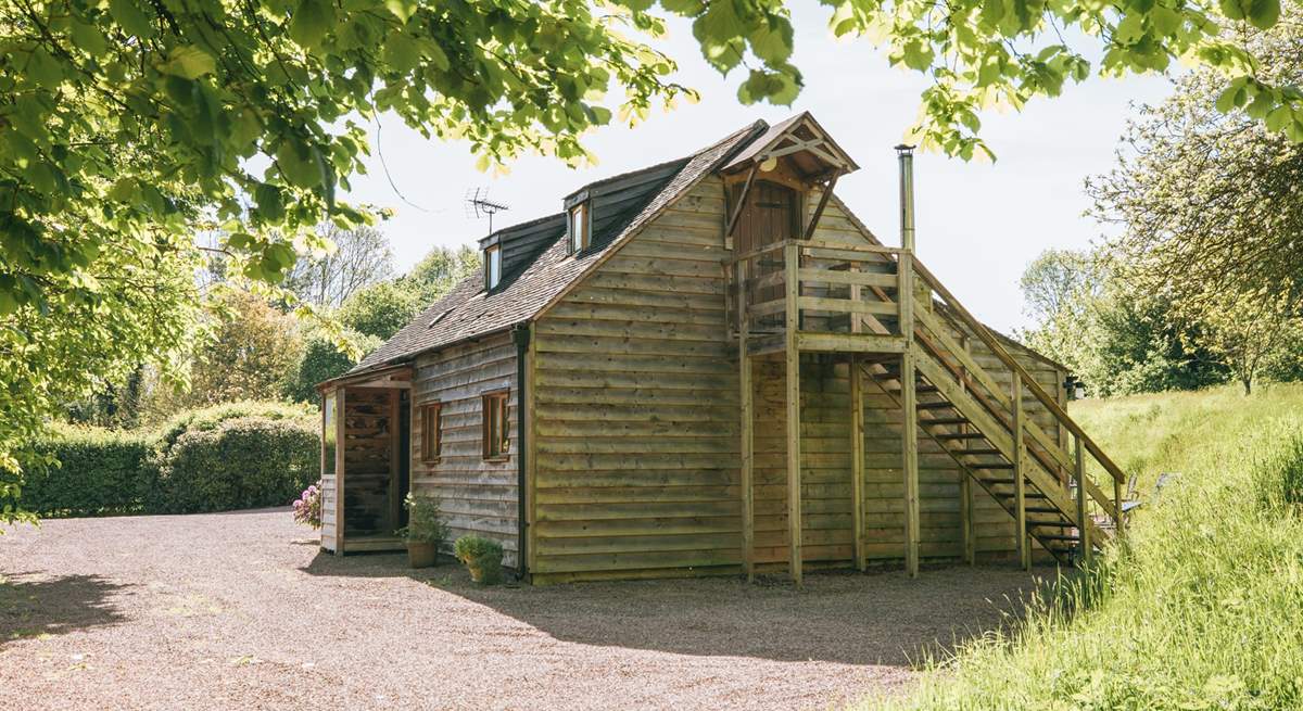 The upstairs bedroom is accessible via an outdoor staircase.