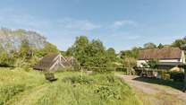 The barn is situated within the serene surroundings of Botloes Farm.