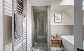 The bathroom boasts a shower cubicle and a bathtub. - Thumbnail Image