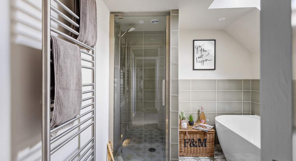 The bathroom boasts a shower cubicle and a bathtub.