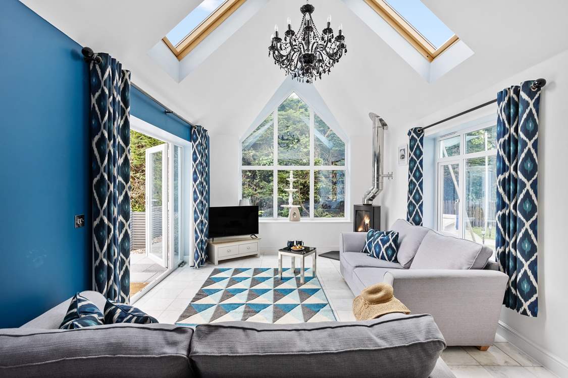 This delightful sitting area is to the side of the kitchen. Doors lead to the secure patio-area with outdoor seating.