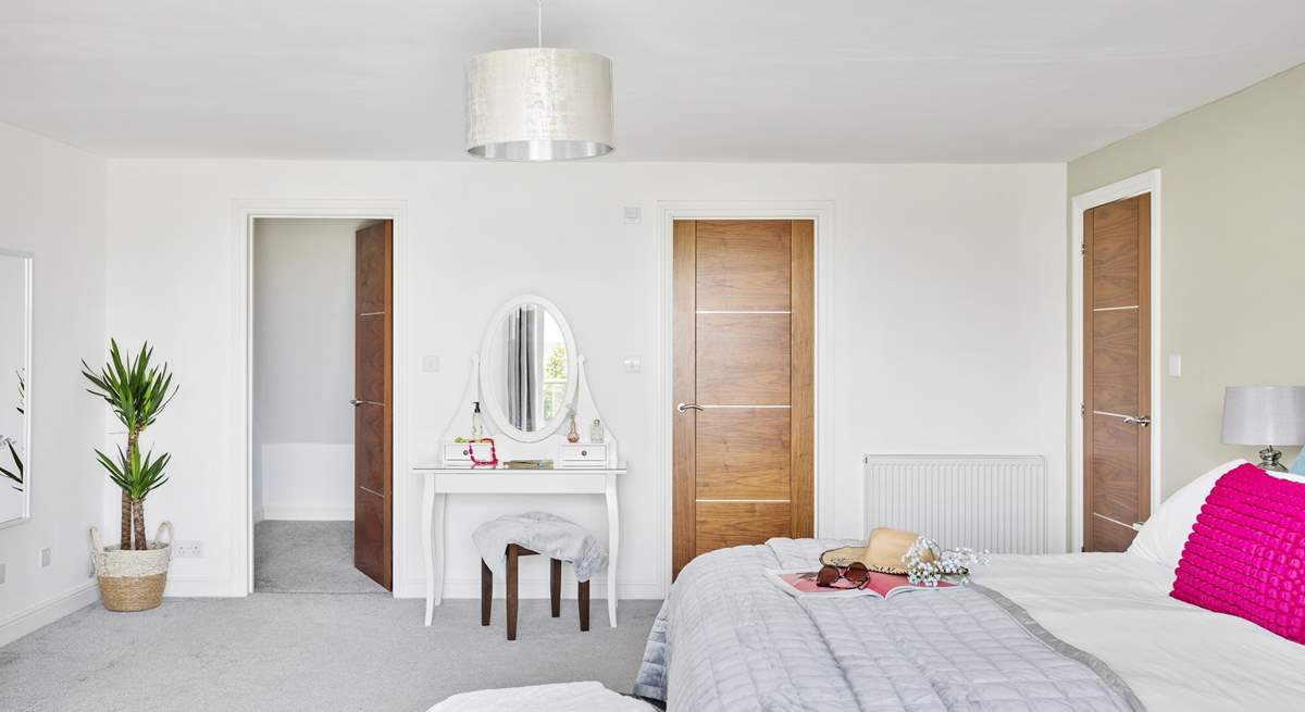 This bedroom has a walk-in wardrobe as well and a swish en suite shower-room.