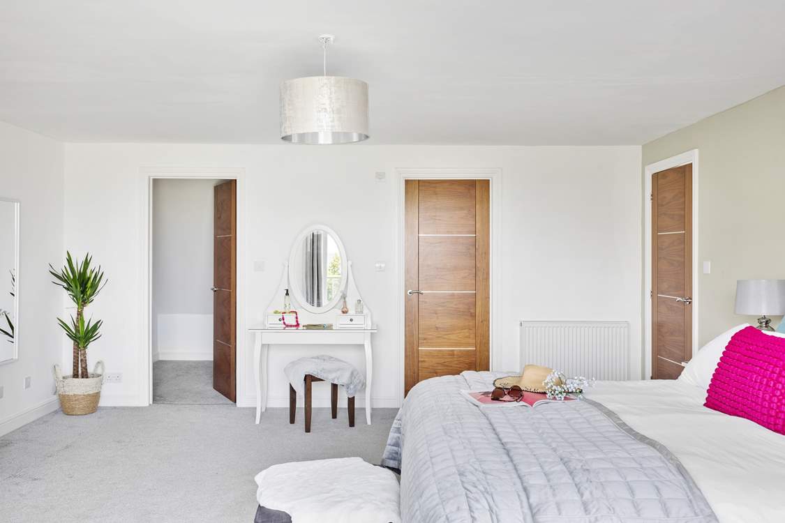 This bedroom has a walk-in wardrobe as well and a swish en suite shower-room.