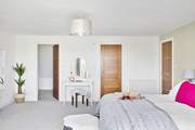 This bedroom has a walk-in wardrobe as well and a swish en suite shower-room.
