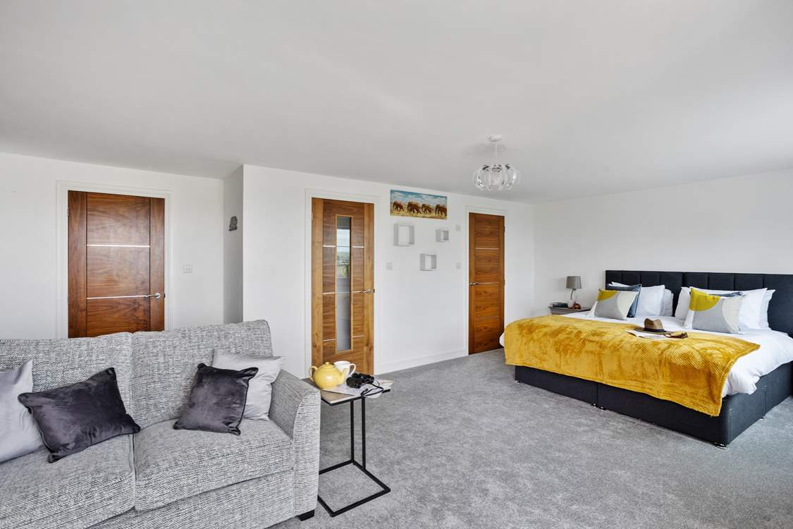 If required the sofa converts into a double bed. This room also has a walk-in wardrobe and an en suite shower-room.
