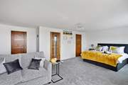 If required the sofa converts into a double bed. This room also has a walk-in wardrobe and an en suite shower-room.