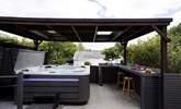 The sociable hot tub area sits to the front of the house, the perfect spot for all the family to enjoy. - Thumbnail Image