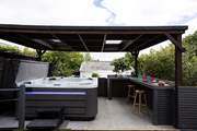 The sociable hot tub area sits to the front of the house, the perfect spot for all the family to enjoy.