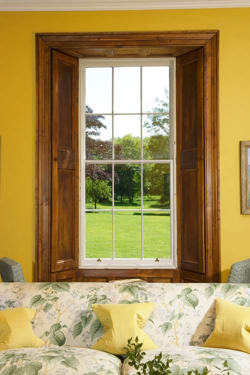 The window perfectly frames the beautiful view of the grounds..