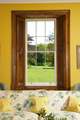 The window perfectly frames the beautiful view of the grounds..