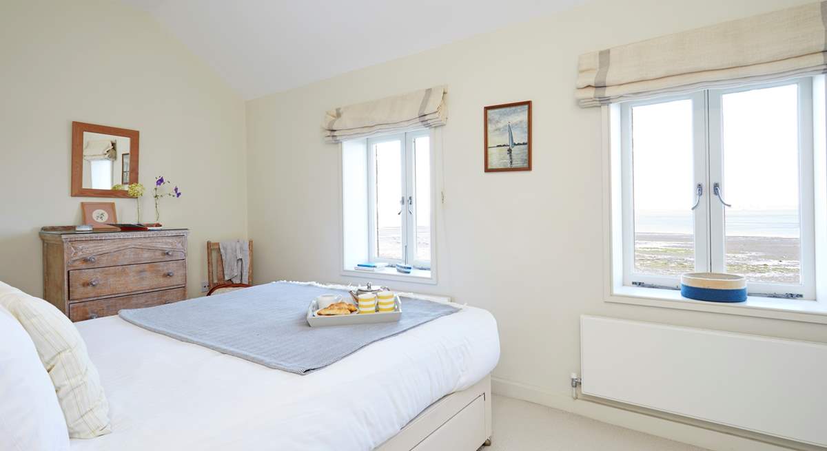 Soft bedroom interiors beautifully complement the coastal surroundings.