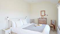 Crisp white linens and neutral interiors create stylish continuity.  
