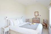 Crisp white linens and neutral interiors create stylish continuity.
