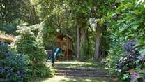 A children's play-area and cooling shady areas in the garden.