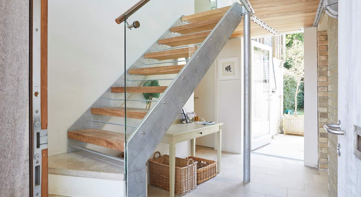 The welcoming entrance hall with its stylish staircase ascending to the first floor. 