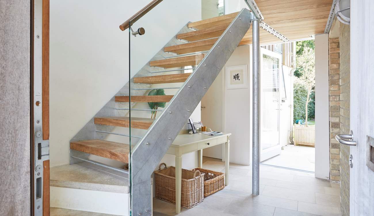 The welcoming entrance hall with its stylish staircase ascending to the first floor. 