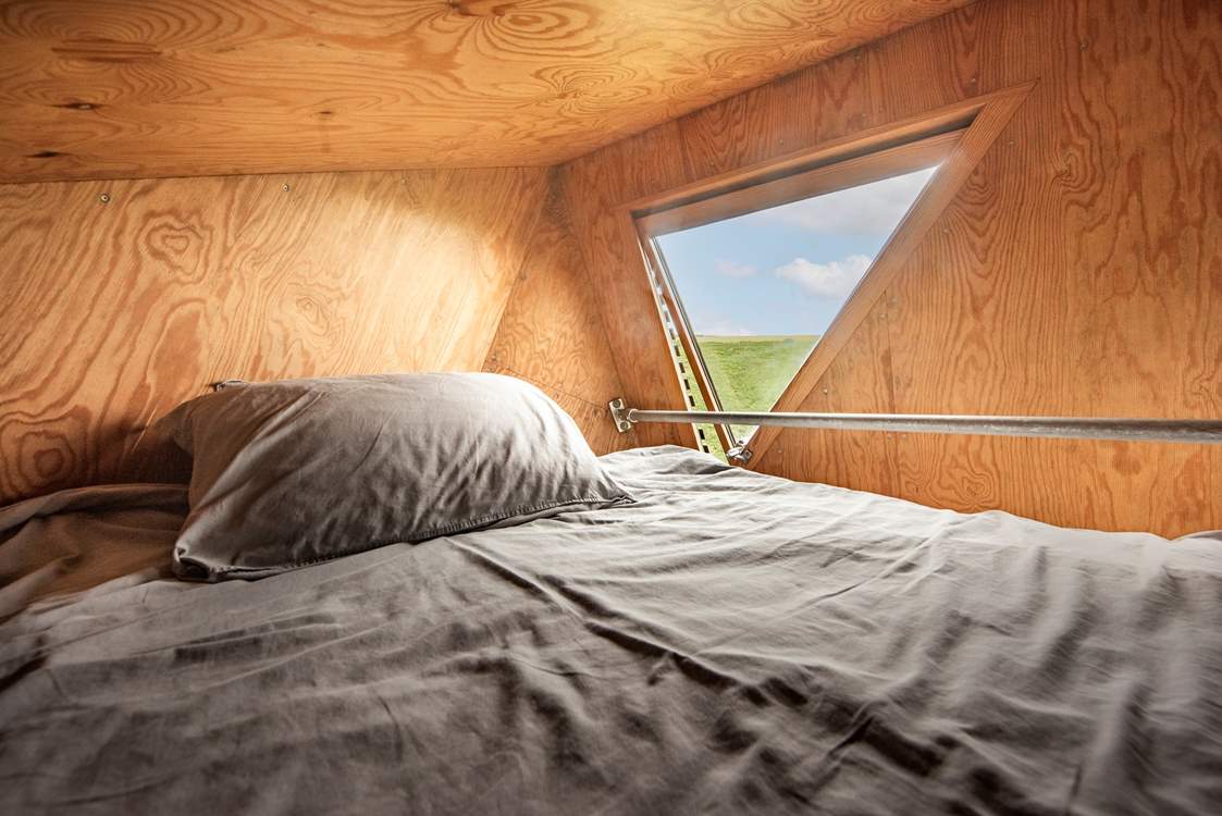The snug double bed is the perfect spot for a restful night's sleep.