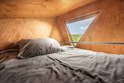 The snug double bed is the perfect spot for a restful night's sleep.