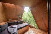 Relax in your treetop escape, with a book surrounded by nature.