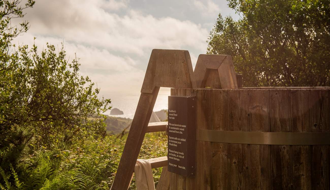 Unwind in the standing wood fired hot tub taking in the sea views.