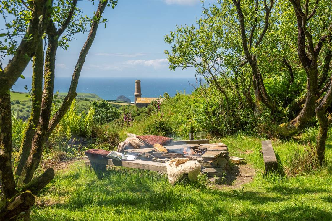 Relax around the communal fire pit and soak up those sea views.