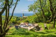Relax around the communal fire pit and soak up those sea views.