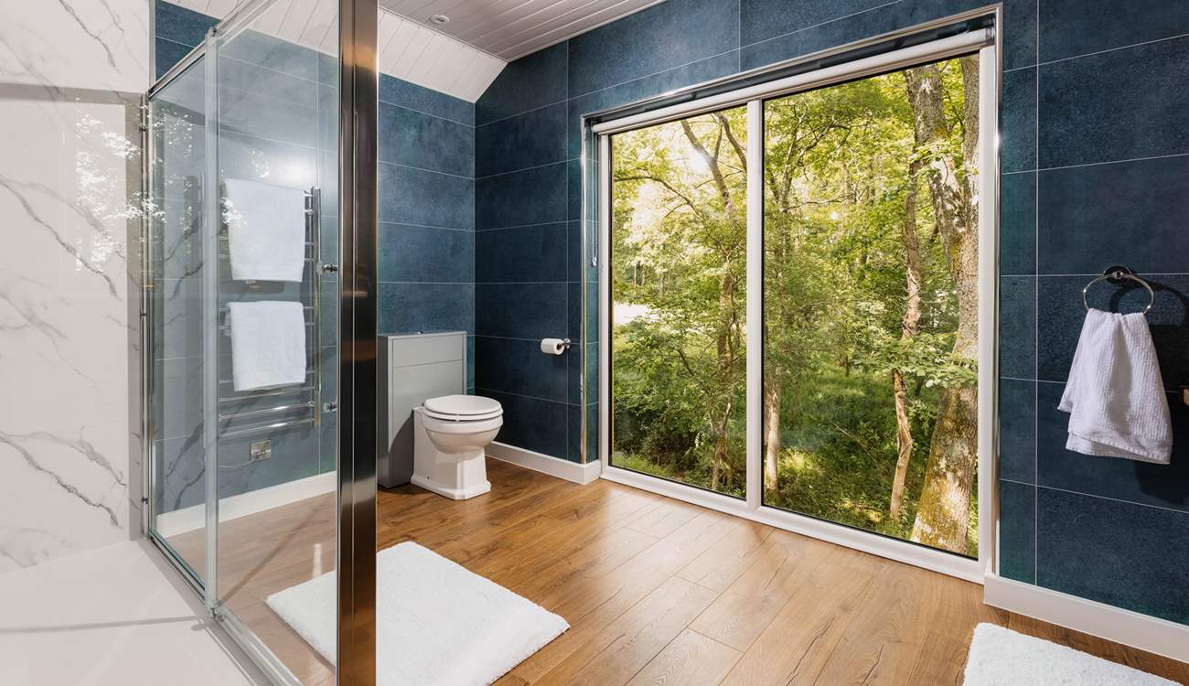 The view welcomes the outdoors in, with large open windows. 
