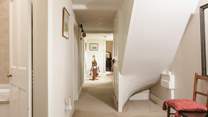 The first floor hallway leads to to a family bathroom and additional bedrooms.