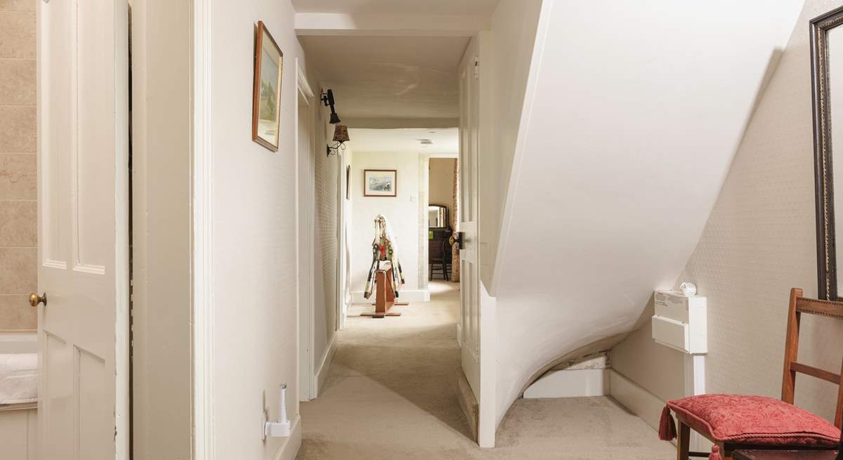 The first floor hallway leads to to a family bathroom and additional bedrooms.