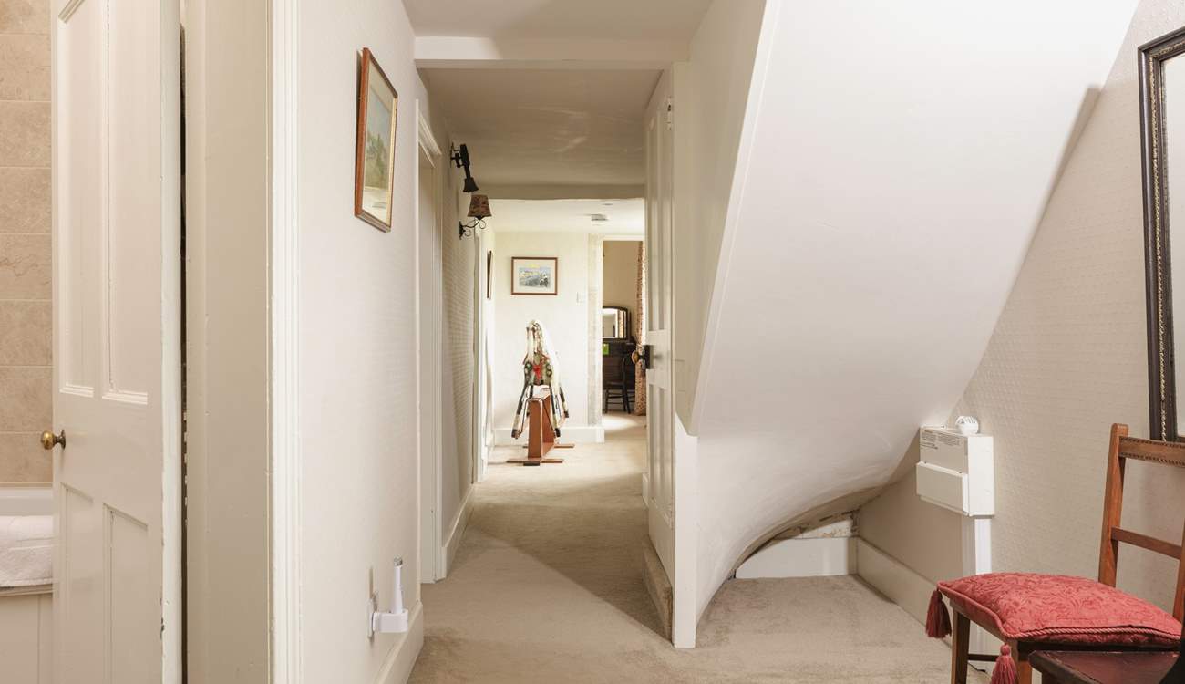 The first floor hallway leads to to a family bathroom and additional bedrooms.