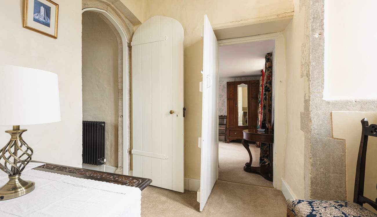 The bedroom leads off to a second staircase that takes you downstairs to the snug.