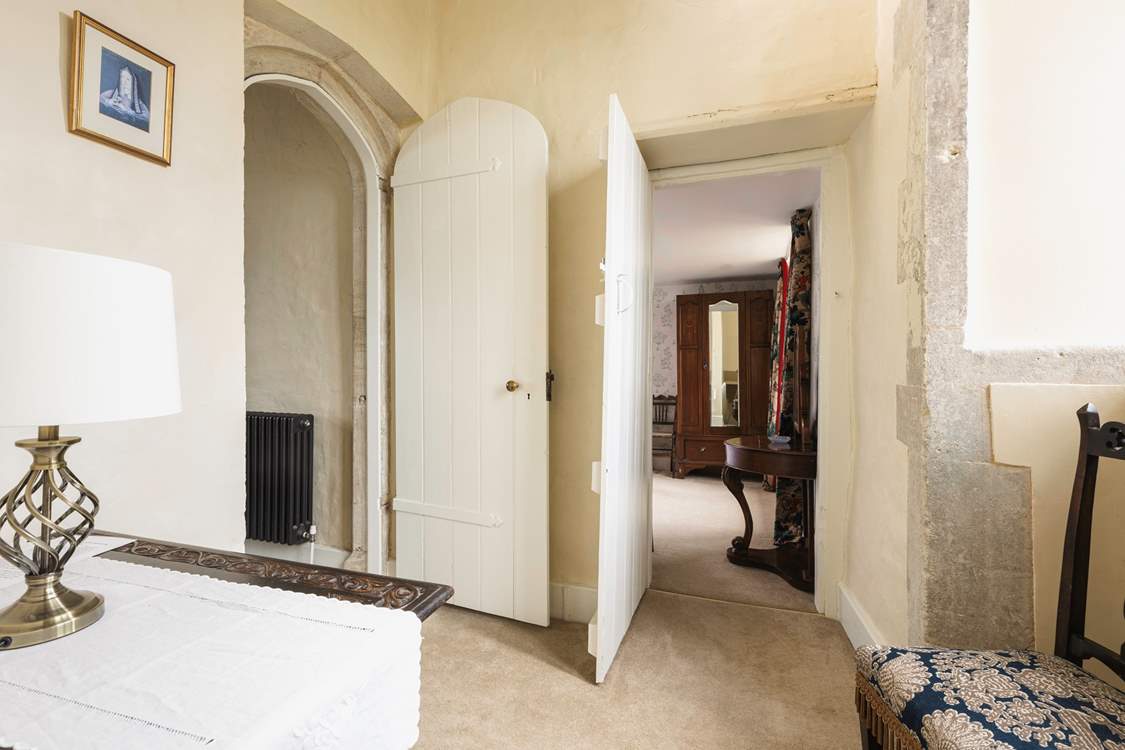 The bedroom leads off to a second staircase that takes you downstairs to the snug.